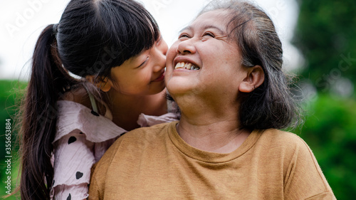 Grandmother and granddaughter enjoyed in the garden.Asian family conception