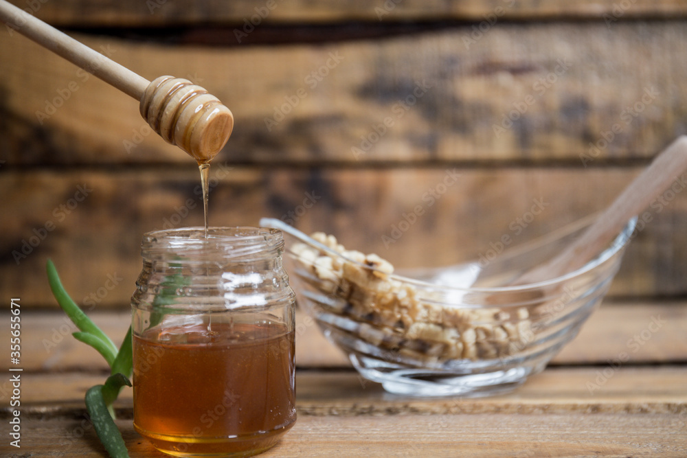 Composition with walnuts and honey on a wooden background Composition with walnuts and honey on a wooden background