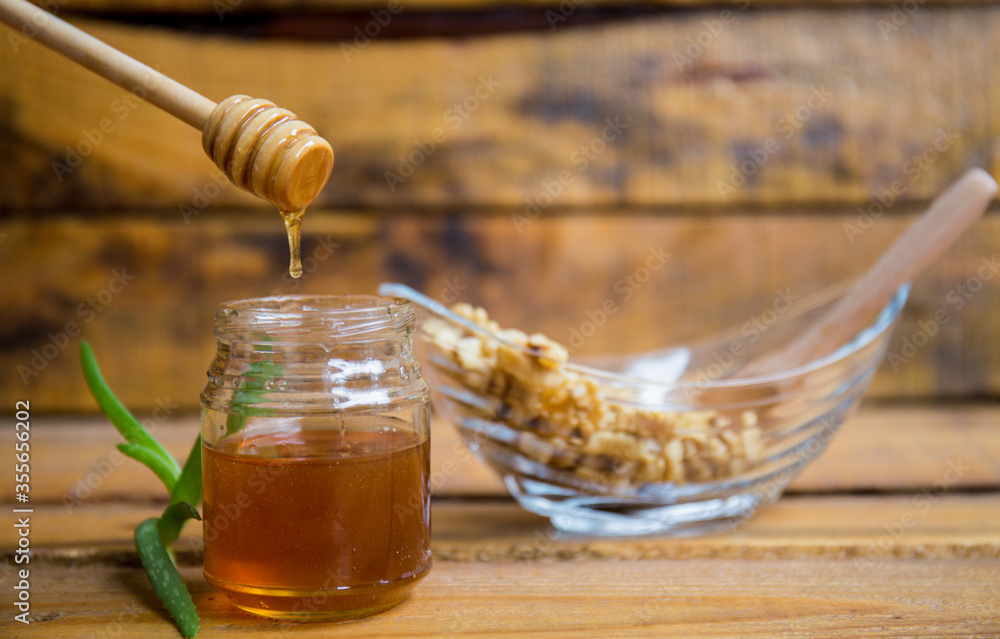 Composition with walnuts and honey on a wooden background Composition with walnuts and honey on a wooden background