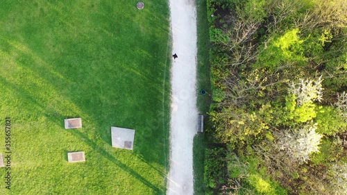 Aerial View of a Sporty Young Woman Jogger Running During Workout In Sunny Summer Park