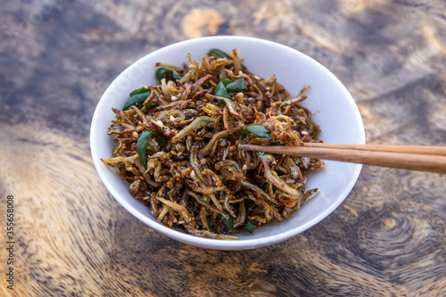 Soy sugar glazed anchovies with green chili which is called Myulchi Bokkeum photo