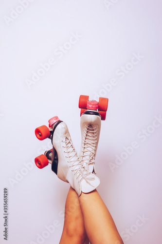 girl with legs up wearing a white 70s roller skates