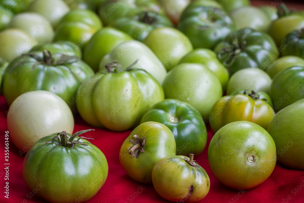 Different types of fresh organic green tomatoes.