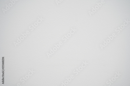 White concrete surface with small pits. Background cement