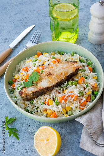 Rice with vegetables and fish steak, traditional asian food