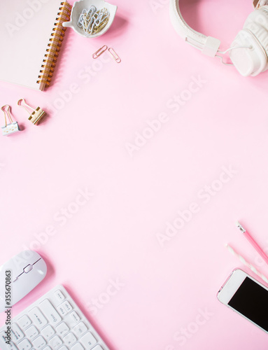 Top view, pink color office desk.