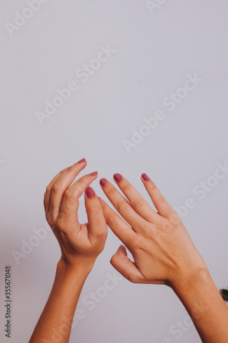 Closeup image of beautiful woman hands, manicure on the nails. Skin care for hands, manicure and beauty treatment. Elegant and graceful hands with slim and graceful fingers