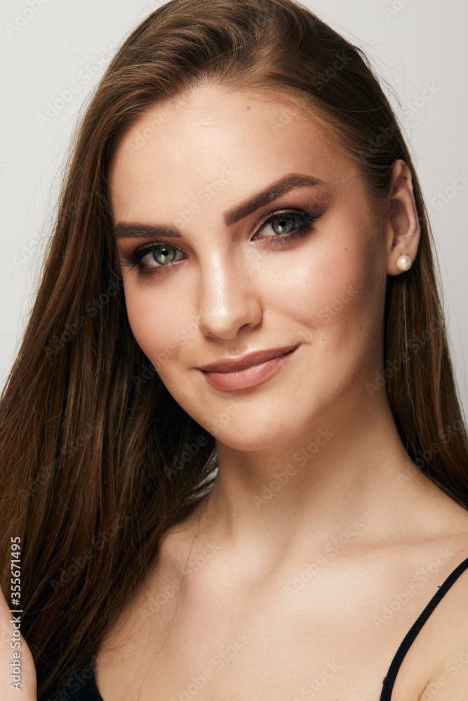 Beautiful face of young woman with clean fresh skin close up isolated on the grey background. Beauty portrait. Perfect fresh skin. Pure beauty model. Youth and skin care concept Beautiful face of young woman with clean fresh skin close up isolated on the grey background. Beauty portrait. Perfect fresh skin. Pure beauty model. Youth and skin care concept