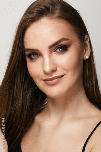 Beautiful face of young woman with clean fresh skin close up isolated on the grey background. Beauty portrait. Perfect fresh skin. Pure beauty model. Youth and skin care concept