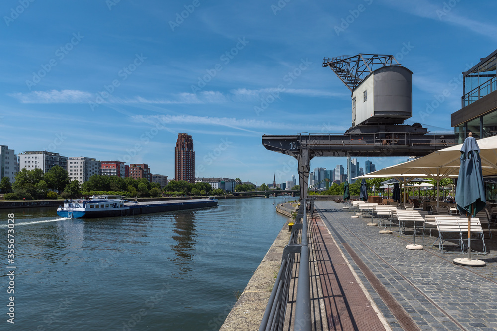 old crane and restaurant in Osthafen on the banks of the Main river in Frankfurt, Germany