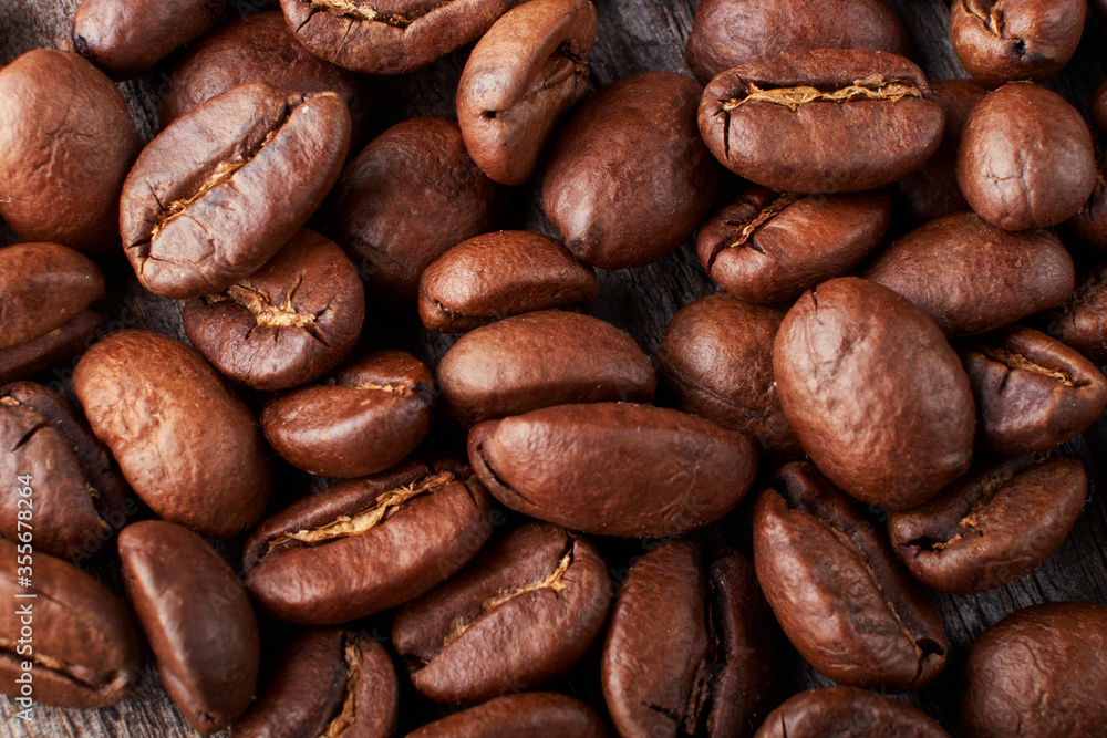 coffee beans close up on a wooden background coffee beans close up on a wooden background