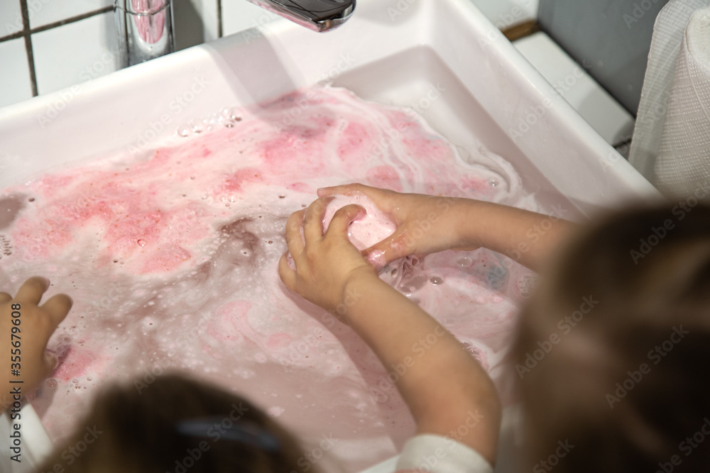 Fototapeta premium Hygiene and care, children wash their hands in the sink.