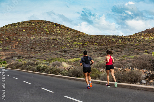 couple jogging on a mountain road