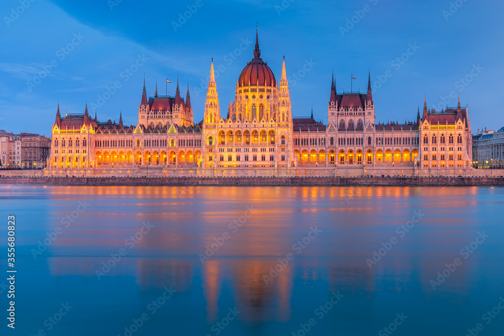 Hungarian Parliament, Budapest with reflection in Danube river during twilight Hungarian Parliament, Budapest with reflection in Danube river during twilight