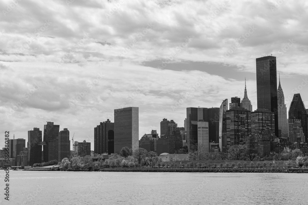 Black and White Manhattan Skyline along the East River in New York City with a Cloudy Sky