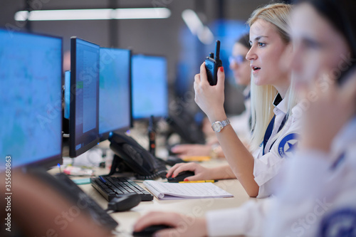 Plakat Female operator working in a security data system control room