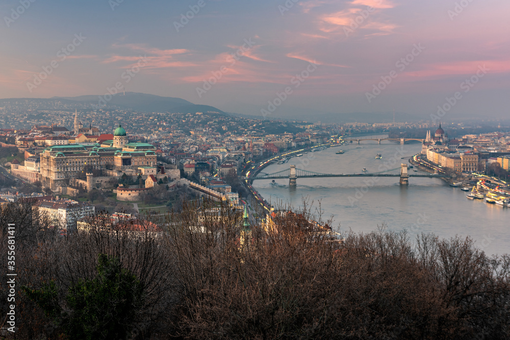 Budapest skyline with Buda castle and Szechenyi Chain Bridge reflect in Danube river during twilight