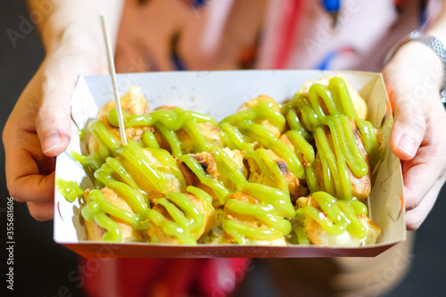 Homemade grill chinese bread stick (chinese donut or beh teung guai) with pandan cream at Yaowarat Thailand - food concept.