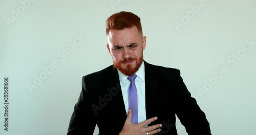Business man feeling nauseated, redhead person nausea reaction photo