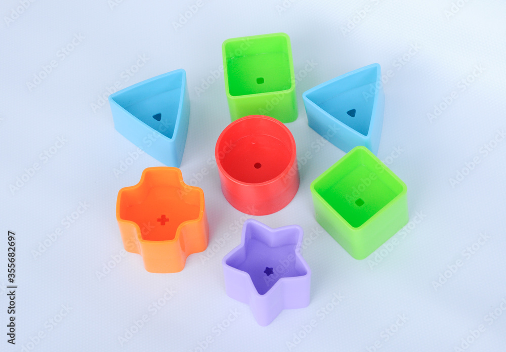 Obraz premium Isolated children's toy blocks in various shapes made of plastic on white background 