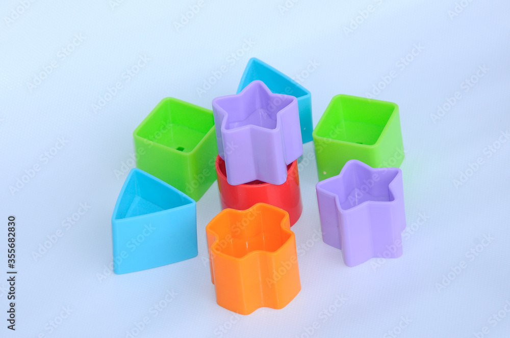 Obraz premium Isolated children's toy blocks in various shapes made of plastic on white background 