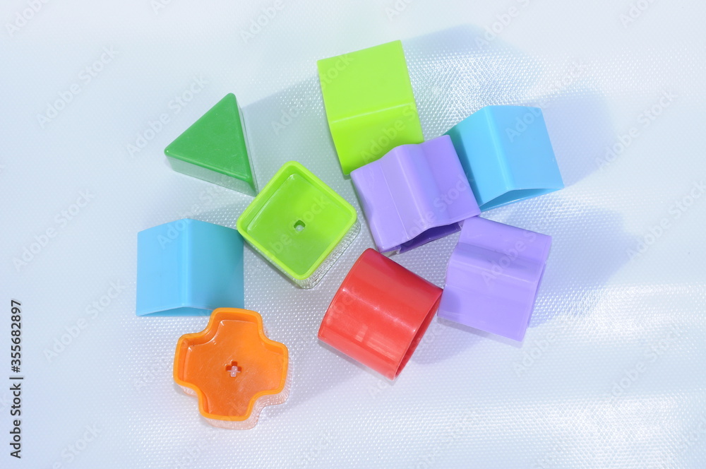 Isolated children's toy blocks in various shapes made of plastic on white background Isolated children's toy blocks in various shapes made of plastic on white background