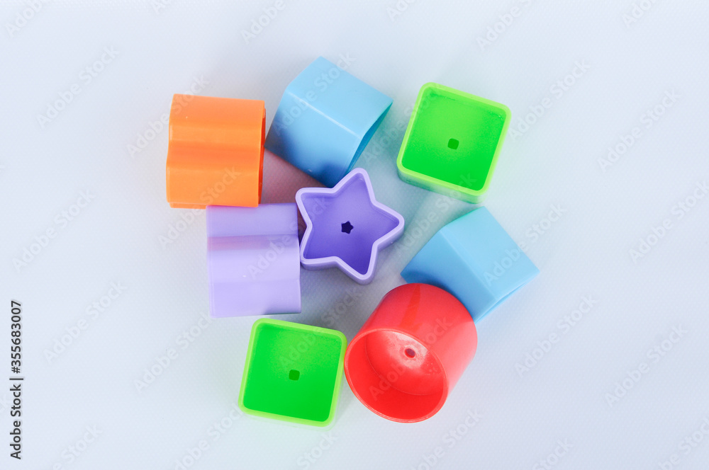 Obraz premium Isolated children's toy blocks in various shapes made of plastic on white background