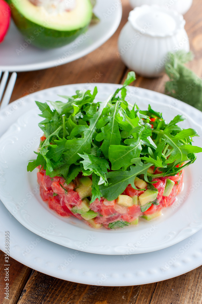 salad with avocado, tomato and red fish with arugula, selective focus salad with avocado, tomato and red fish with arugula, selective focus