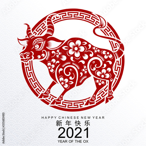 Chinese new year 2021 year of the ox , red paper cut ox character,flower and asian elements with craft style on background.(Chinese translation : Happy chinese new year 2021, year of ox)