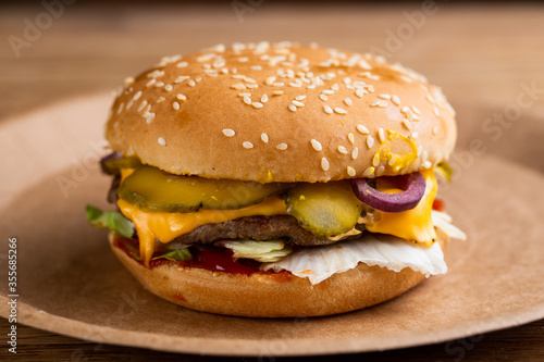beef patty cheeseburger with pickles and cheese