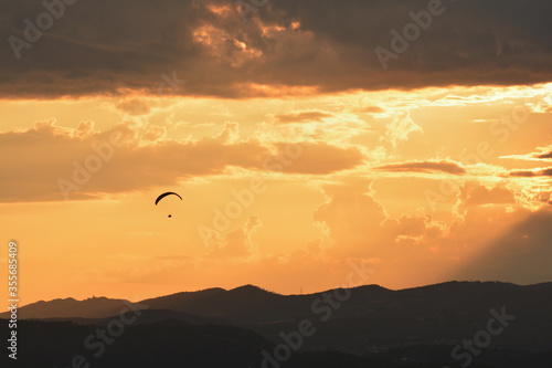 Paragliding in an orange sunset