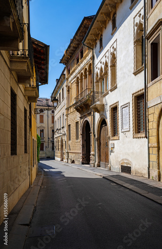 Fototapeta Naklejka Na Ścianę i Meble -  A street in the historic center of the city of Vicenza characterized by noble palaces of different eras and styles, Renaissance, Venetian Gothic and nineteenth century. peaceful atmosphere, Italy.
