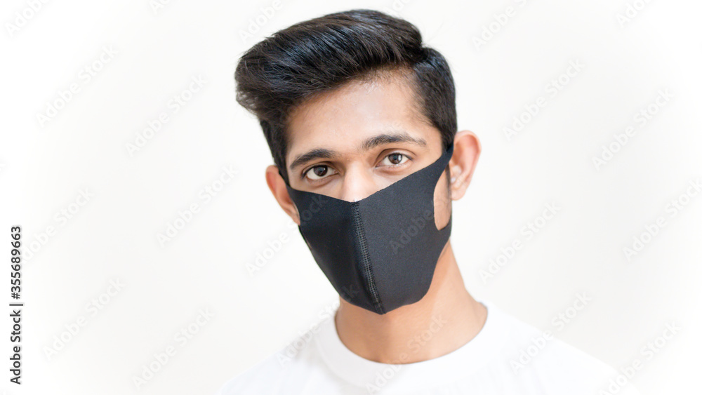 Young asian boy face closeup wearing black surgical mask to protect himself from the corona virus covid 19, black surgical face mask, cloth face mask Young asian boy face closeup wearing black surgical mask to protect himself from the corona virus covid 19, black surgical face mask, cloth face mask