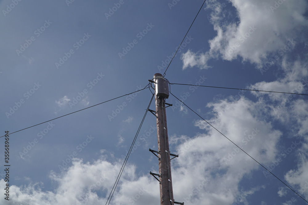Telegraph pole with multiple phone wires attached to a junction box Telegraph pole with multiple phone wires attached to a junction box