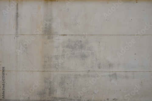 Old concrete wall with horizontal line and tiny vertical long crack surface