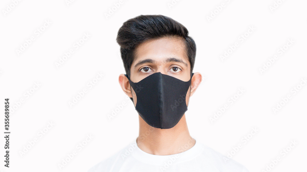 Smart boy wearing black mask to protect himself from the flu and diseases corona virus covid 19, black surgical mask, close up, boy looking in camera, black mask doctor, selective focus Smart boy wearing black mask to protect himself from the flu and diseases corona virus covid 19, black surgical mask, close up, boy looking in camera, black mask doctor, selective focus