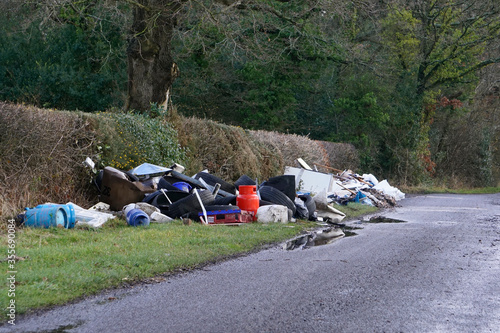 Billede på lærred Fly-tipping or illegal waste dumping in a country lane in the UK