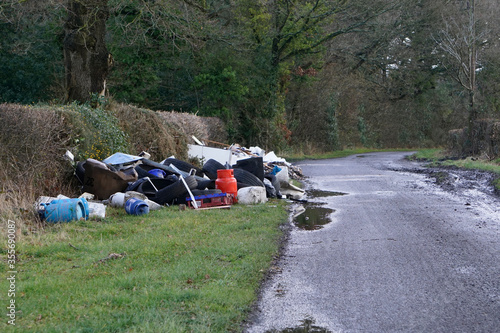 Fly-tipping or illegal waste dumping in a country lane in the UK