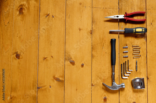Tools and screws over wooden surface