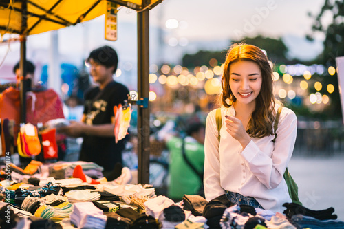 Fotografie, Tablou Happy traveler asian woman in shopping street night market at dusk in Thailand
