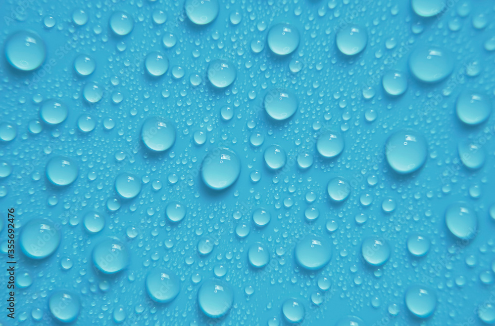 Beautiful big alcohol droplets on the light blue background. 