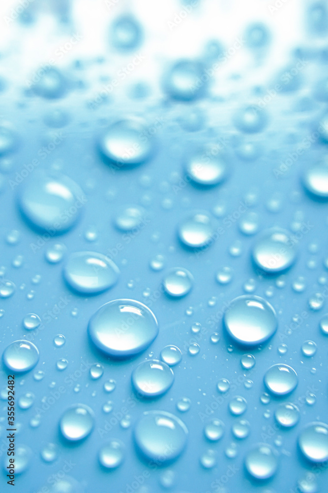 Beautiful big alcohol droplets on the light blue background. Beautiful big alcohol droplets on the light blue background.