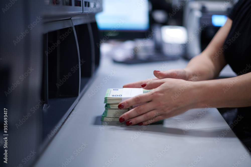 Bank employees sorting and counting paper banknotes Bank employees sorting and counting paper banknotes