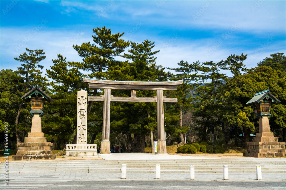 Seidamari Torii in Izumo Taisha Shrine in Shimane Japan with a pillar showing the Kanji characters of Izumo Taisha. It serves as the entrance into the path leading to the shrine