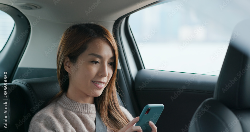 Woman use of smart phone on car