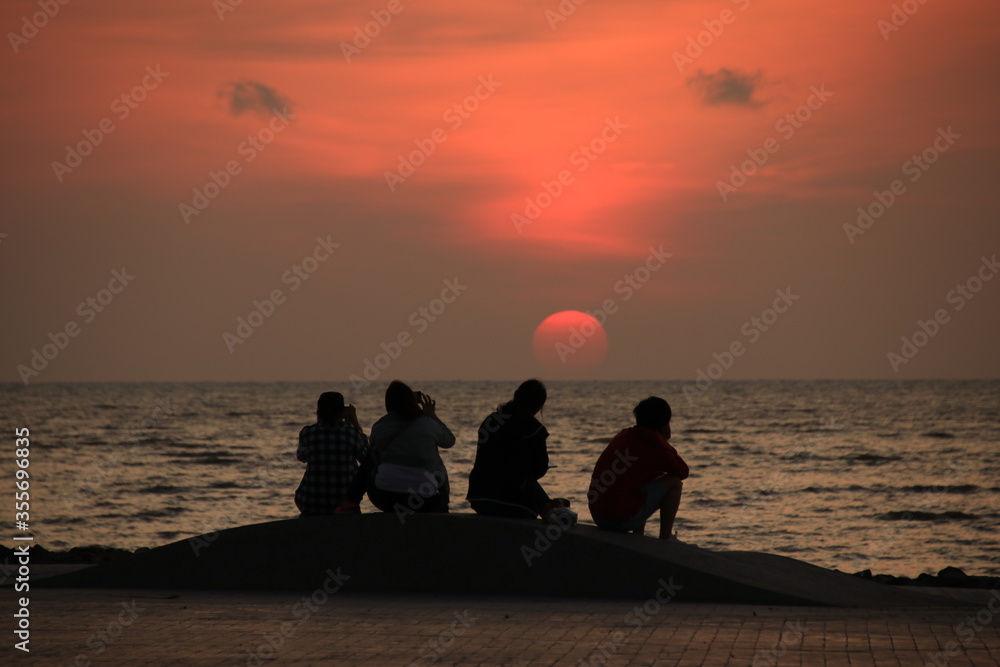 family on the beach at sunrise