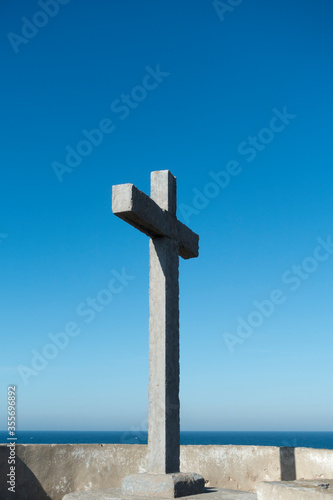 a stone cross which is located overlooking the atlantic ocean at Revelim dos Remedios, Peniche, Portugal