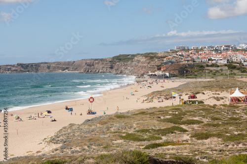 view down to the beach and town Praia da Areia Branca,  near Lourinha on the Portuguese Silver Coast 