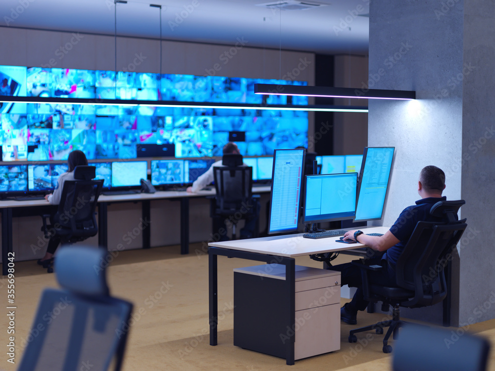 male operator working in a security data system control room male operator working in a security data system control room
