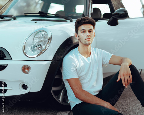 Boy sitting in his white car © Cesc Sugra